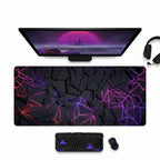 Gaming setup with a large mouse pad featuring geometric design, keyboard, and mouse on a dark surface.